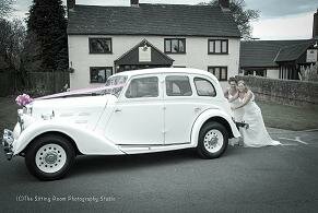 two women pushing car